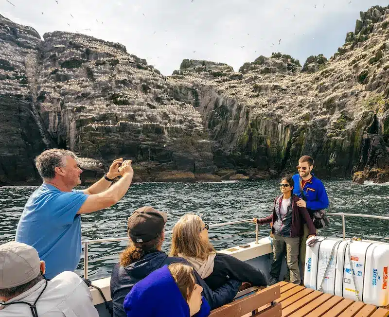 skipper taking photograph of passengers at little skellig