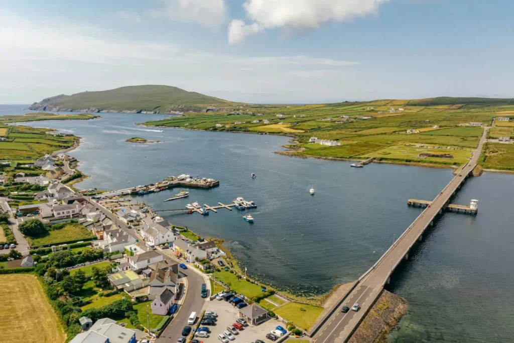 Aerial view of Portmagee, showing boats, bridge, and landscape. Book Skellig Michael boat tours for an amazing experience today.
