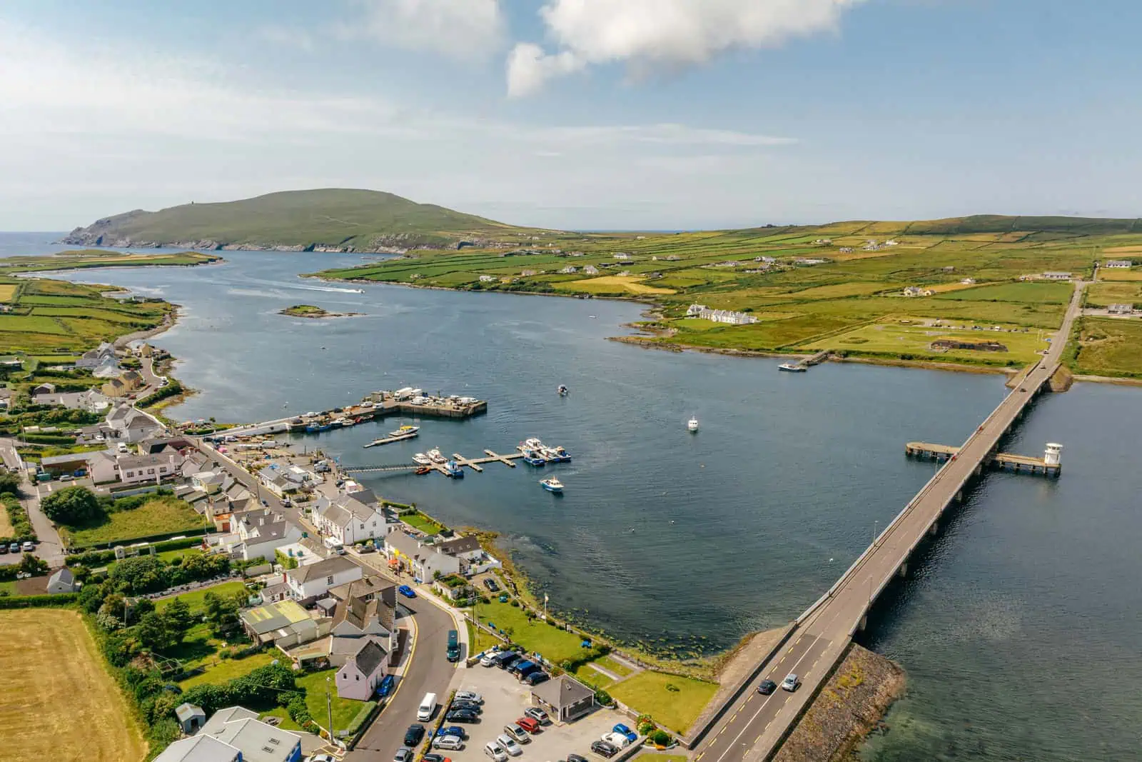 Aerial view of Portmagee, showing boats, bridge, and landscape. Book Skellig Michael boat tours for an amazing experience today.