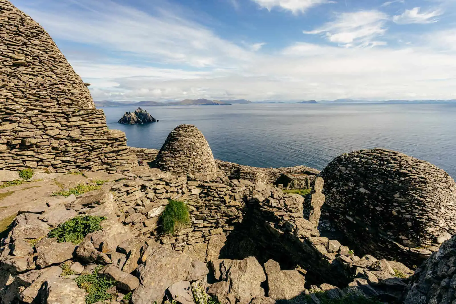 Stone beehive huts on Skellig Michael, overlooking the Atlantic. Explore this UNESCO site with Skellig Michael boat tours. 